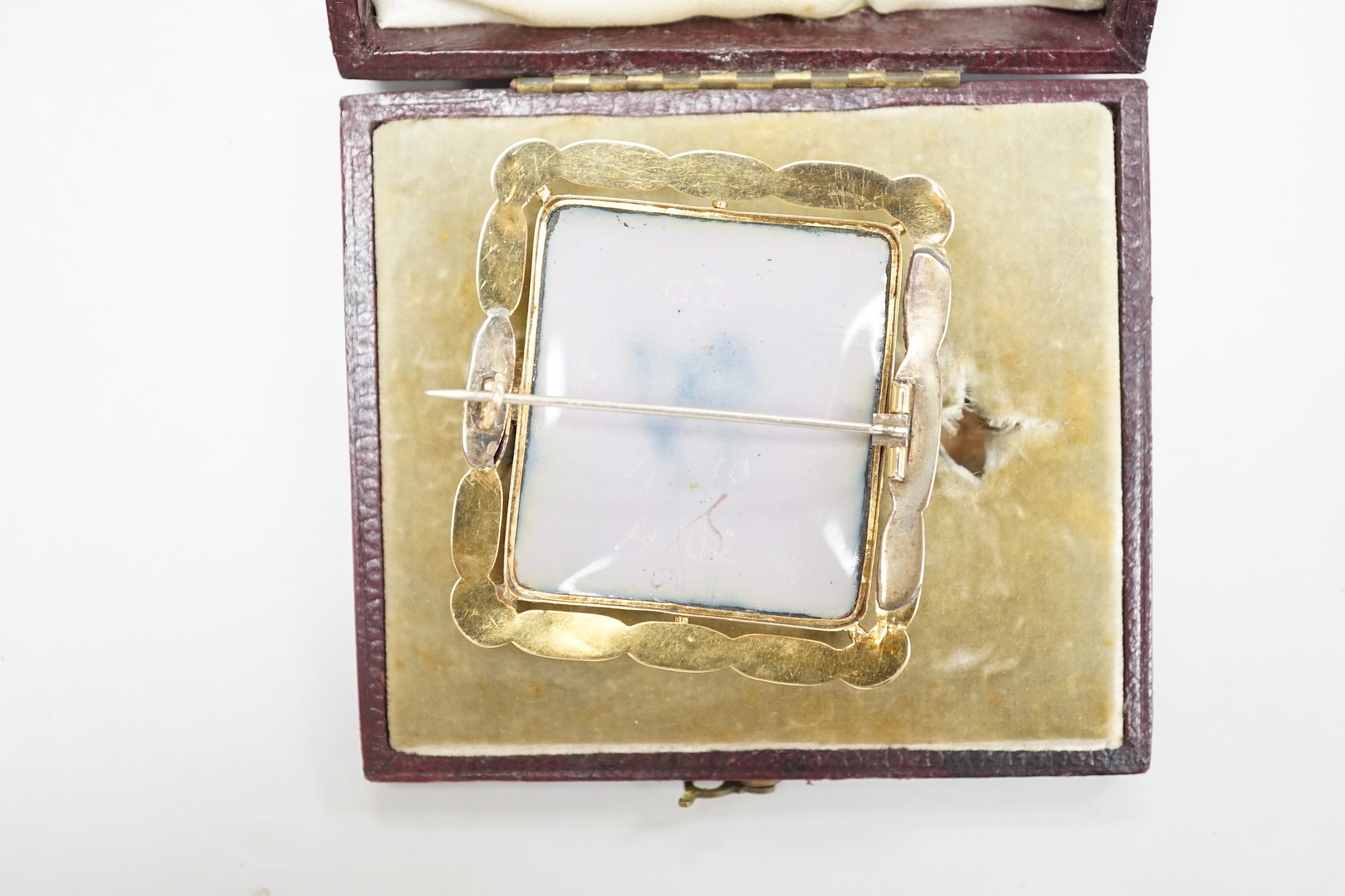 A cased Swiss? yellow metal, enamel and seed pearl mounted enamelled portrait brooch, 48mm, 13.8 grams.
